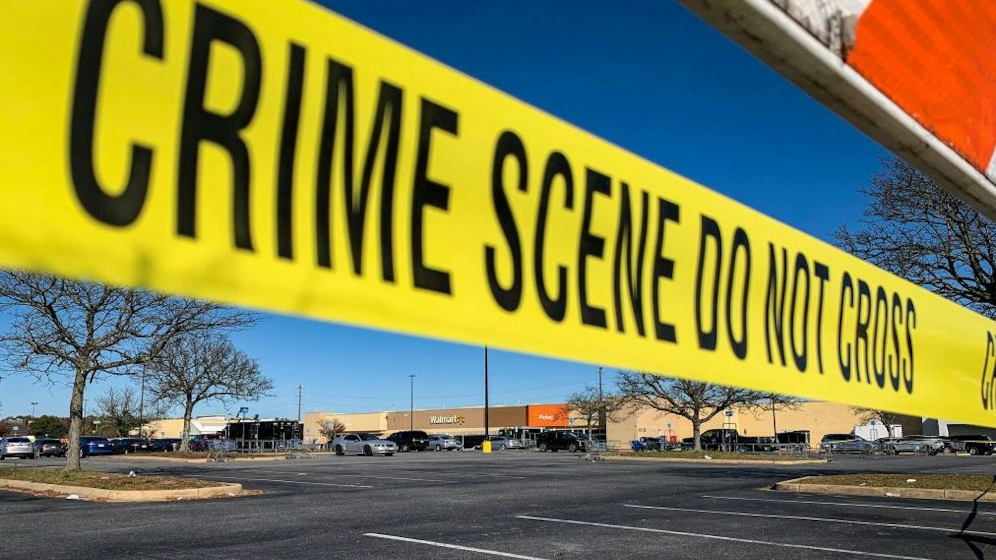 Crime scene tape blocks the parking lot outside of a Walmart following a mass shooting the night before in Chesapeake, Virginia on November 23, 2022.