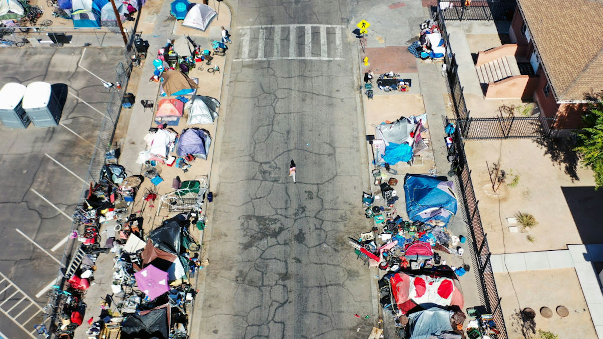 An aerial view of people gathered near a homeless encampment in the afternoon heat on July 21, 2022 in Phoenix, Arizona.