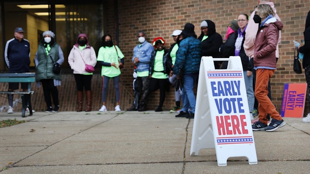 People wait in line outside a polling place at the start of early voting on October 25, 2022 in Milwaukee, Wisconsin. Early voting for the mid-term election begins today in Wisconsin.