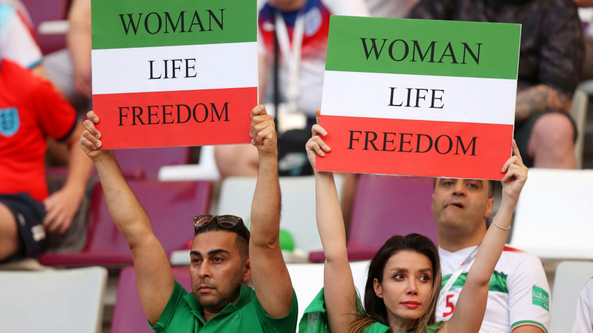 DOHA, QATAR - NOVEMBER 21: Iranian fans hold up signs advocating for women's rights prior to the FIFA World Cup Qatar 2022 Group B match between England and IR Iran at Khalifa International Stadium on November 21, 2022 in Doha, Qatar. (Photo by