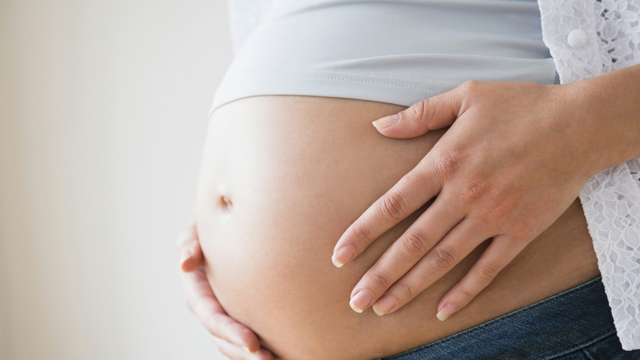 Close-up of pregnant woman's belly - stock photo