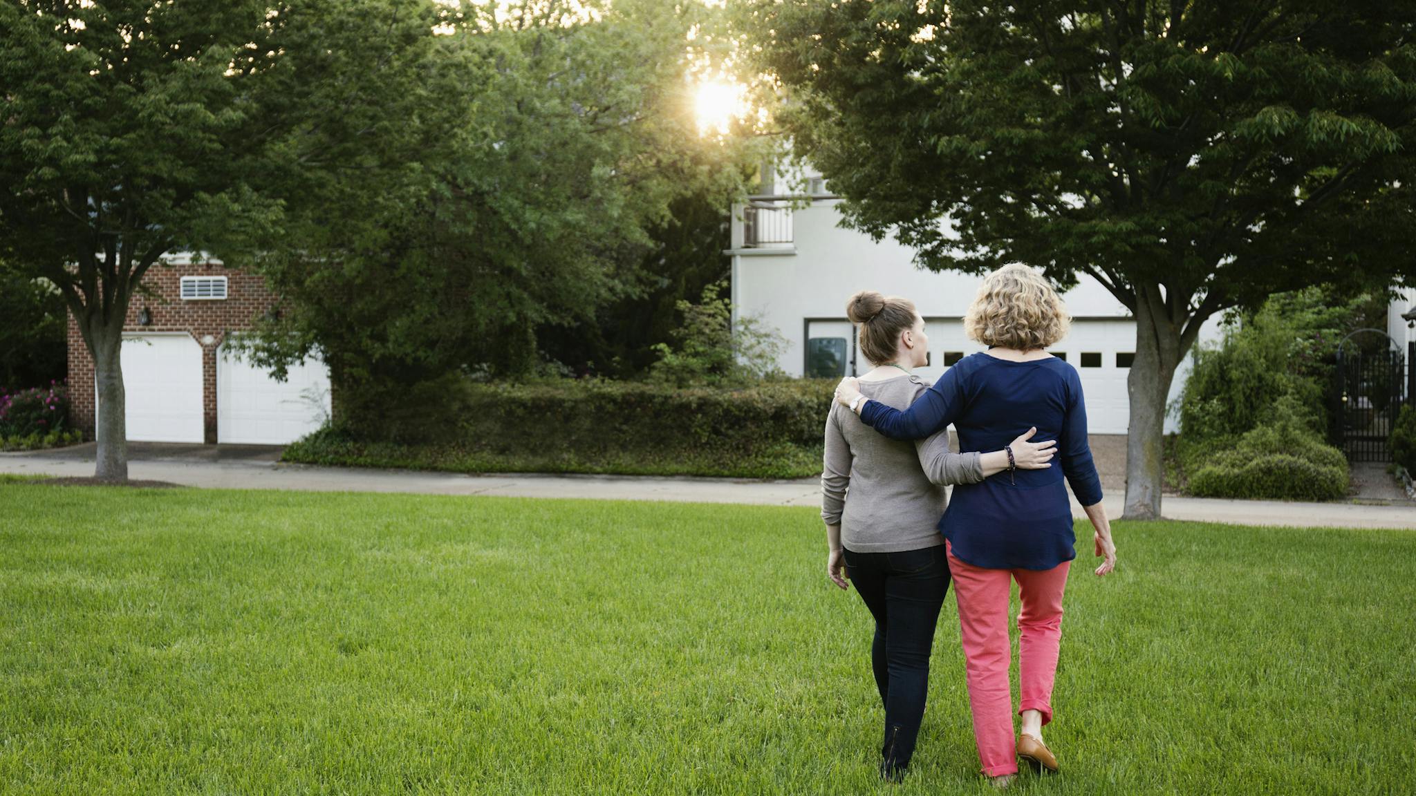 Caucasian mother and daughter walking in park Caucasian mother and daughter walking in park