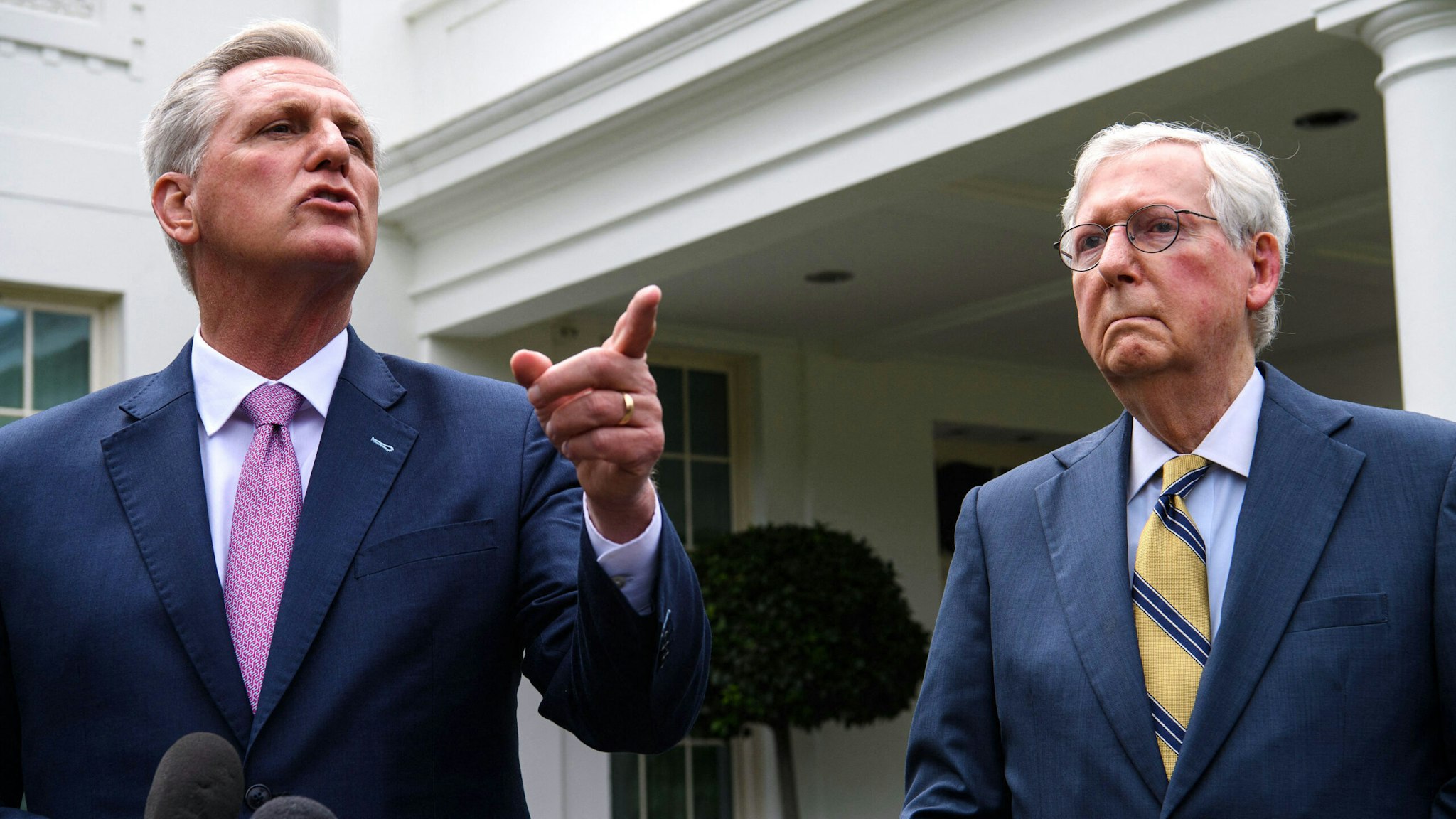 US Senate Minority Leader Mitch McConnell(R)listens as House Minority Leader Kevin McCarthy speaks to the press, following their meeting with US President Joe Biden and Democratic congressional leaders at the White House in Washington, DC, on May 12, 2021.
