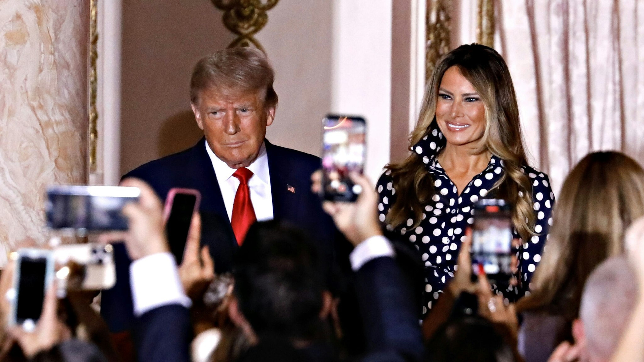 Former US President Donald Trump, center, arrives to speak with former First Lady Melania Trump, center right, at the Mar-a-Lago Club in Palm Beach, Florida, US, on Tuesday, Nov. 15, 2022. Trump formally entered the 2024 US presidential race, making official what he's been teasing for months just as many Republicans are preparing to move away from their longtime standard bearer.