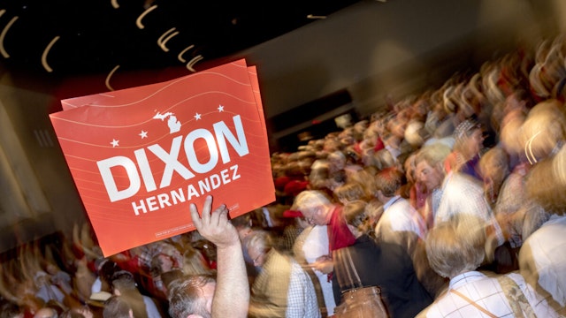An attendee holds a campaign sign for Tudor Dixon, Republican gubernatorial candidate for Michigan, and Shane Hernandez, Republican lieutenant gubernatorial candidate for Michigan, during the MIGOP Nominating Convention in Lansing, Michigan, US, on Saturday, Aug. 27, 2022