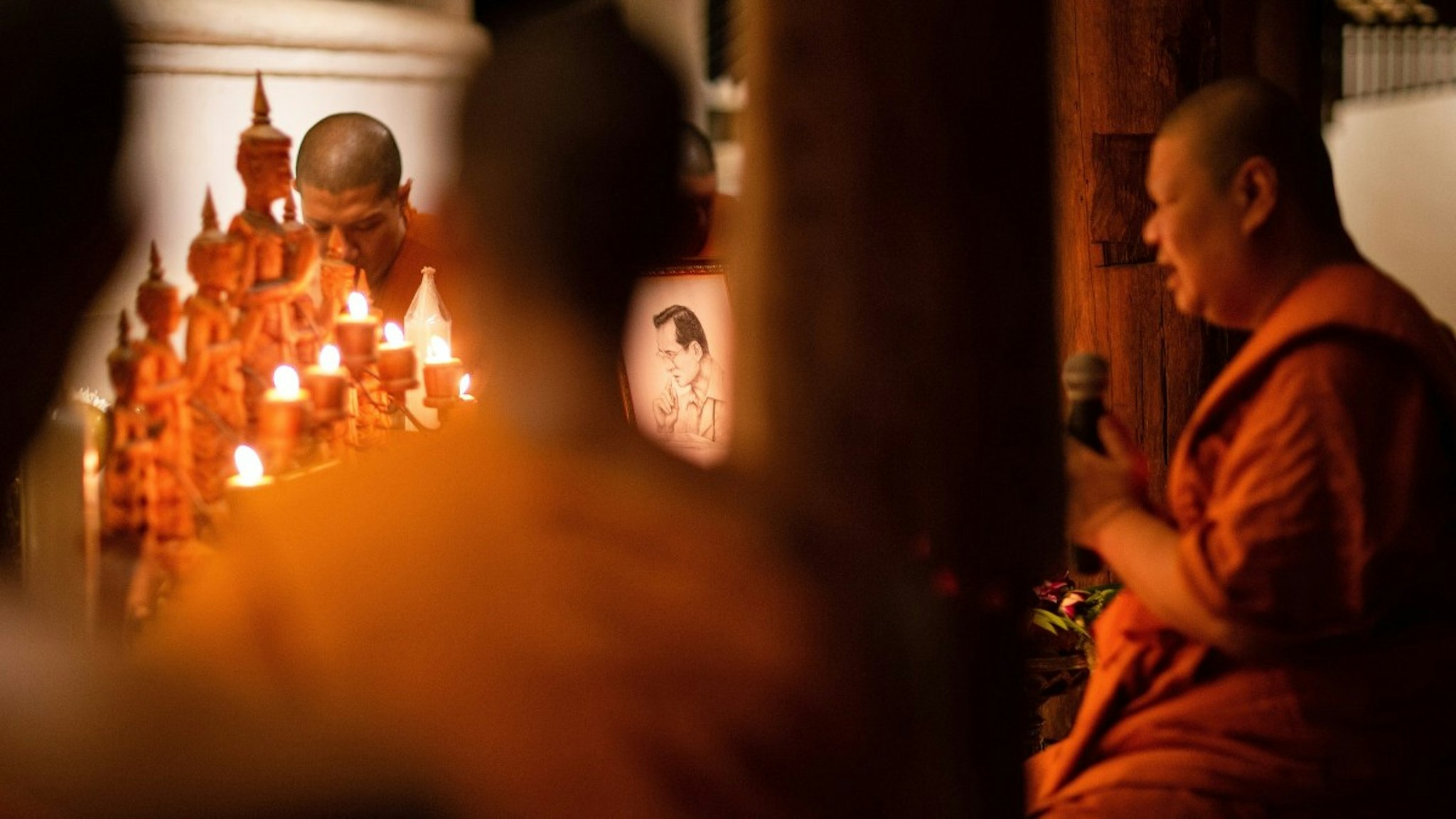 Thai Buddhist monks pray during a religious ceremony to commemorate The 6th death anniversary of Thai King Bhumibol Adulyadej at Wat Pha Lat Temple.