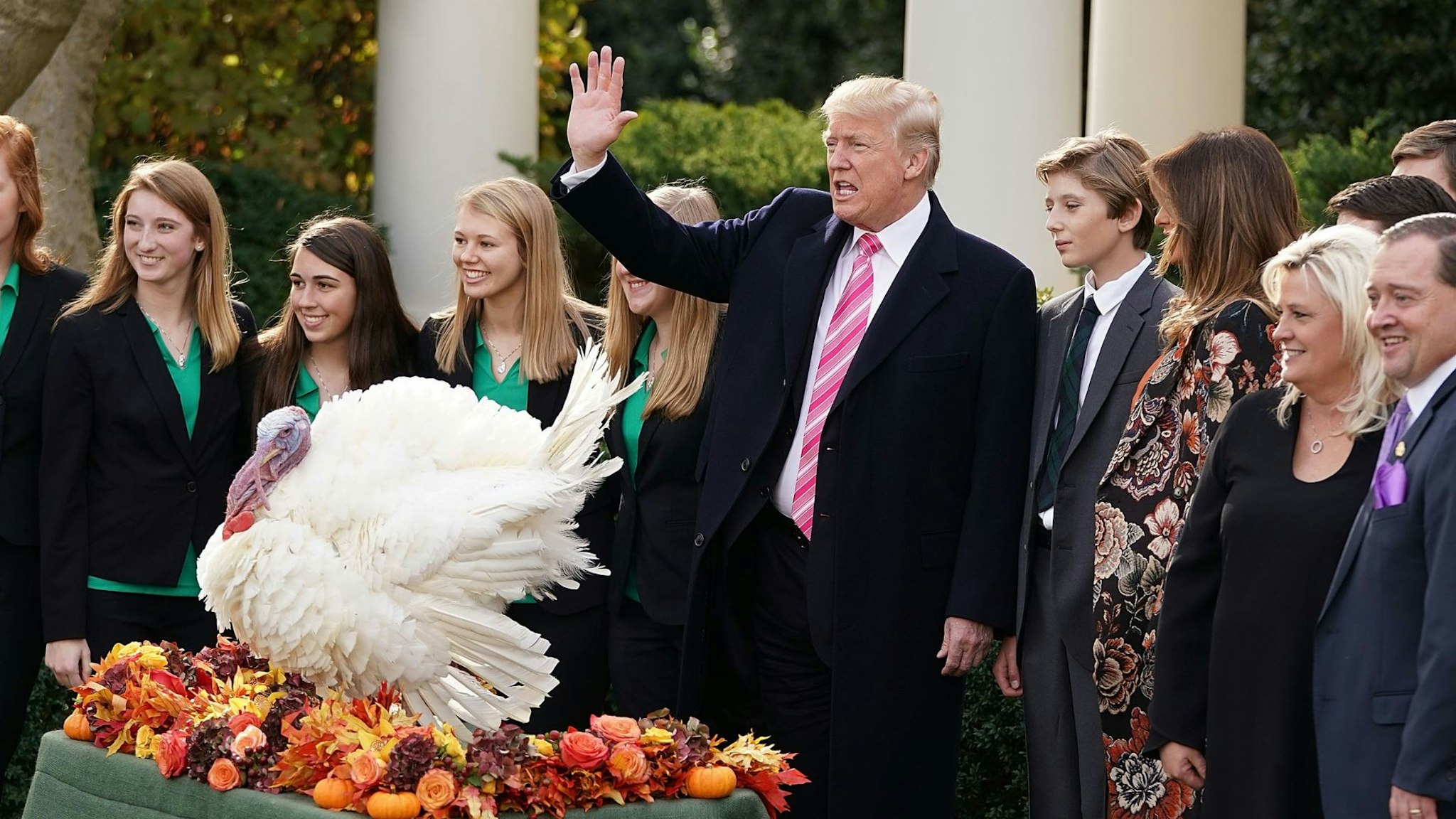 WASHINGTON, DC - NOVEMBER 21: U.S. President Donald Trump (C), first lady Melania Trump, their son Barron, National Turkey Federation Chairman Carl Wittenburg and his family and members of the Draper County, Minnesota, 4-H chapater pose for photographs after Trump pardoned, Drumstick, the National Thanksgiving Turkey in the Rose Garden at the White House November 21, 2017 in Washington, DC. Following the presidential pardon, the 40-pound White Holland breed which was raised by Wittenburg in Minnesota, will then reside at his new home, 'Gobbler's Rest,' at Virginia Tech.