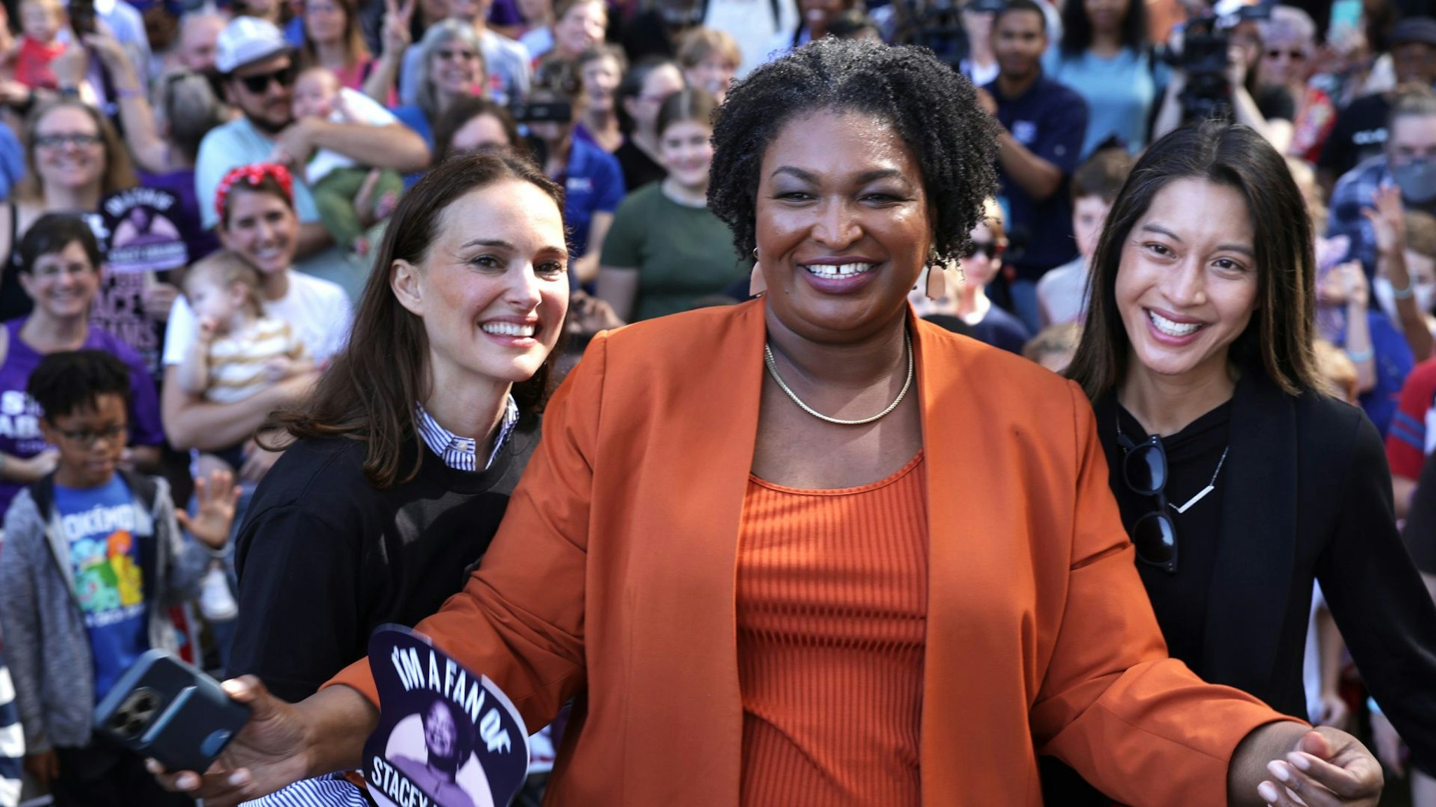 SAVANNAH, GEORGIA - NOVEMBER 05: Democratic Georgia gubernatorial candidate Stacey Abrams (C) poses for photos with supporters, actress Natalie Portman (L) and Democratic candidate for Georgia Secretary of State, and Georgia State House Rep. Bee Nguyen (D-89th District) (R) during a stop of her statewide campaign bus tour on November 5, 2022 in Savannah, Georgia. Abrams continued to campaign to unseat her Republican rival Gov. Brian Kemp (R-GA) in the upcoming midterm election.
