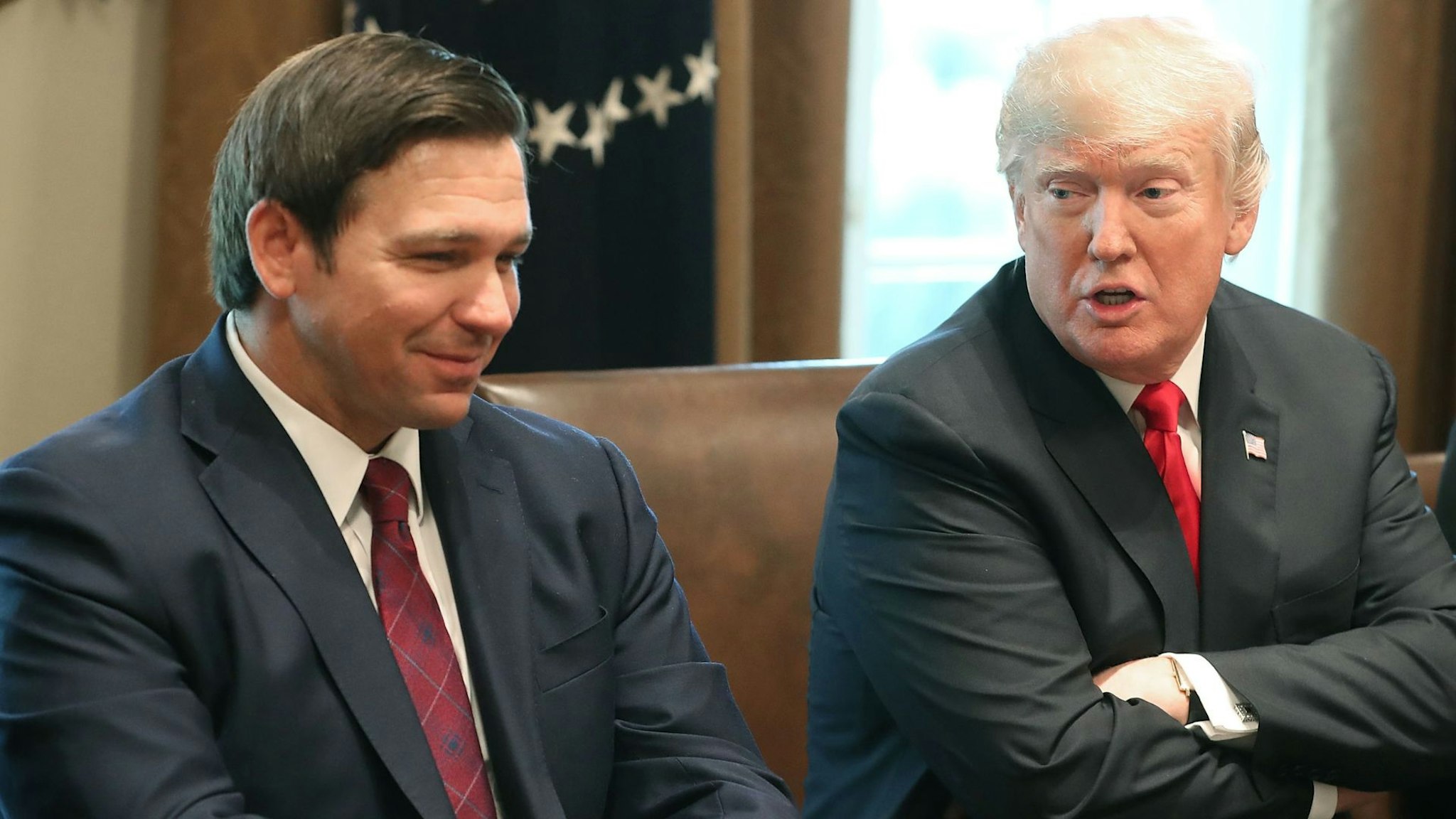 WASHINGTON, DC - DECEMBER 13: Florida Governor-elect Ron DeSantis (R) sits next to U.S. President Donald Trump during a meeting with Governors elects in the Cabinet Room at the White House on December 13, 2018 in Washington, DC.
