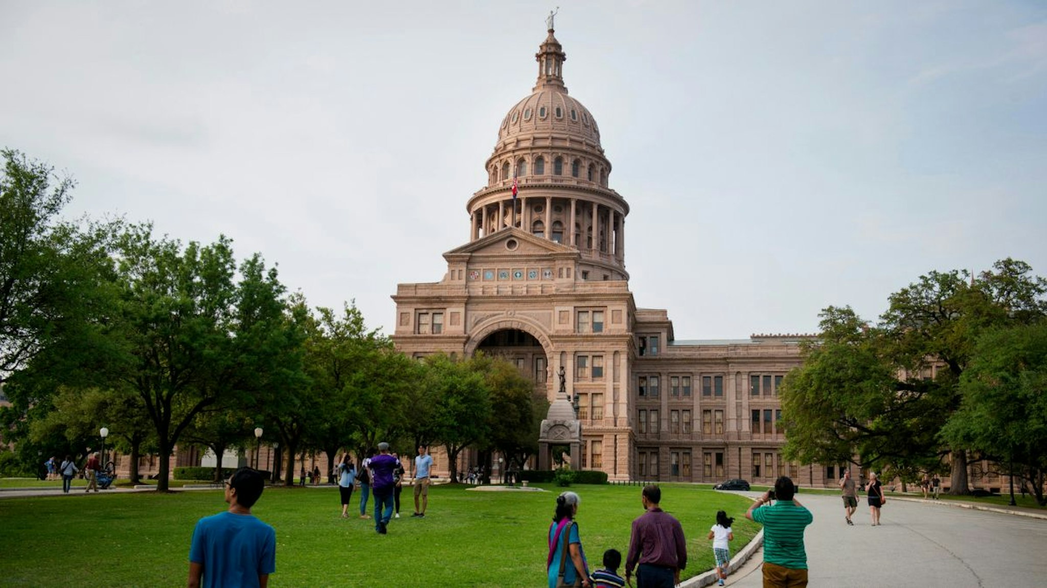 Tourists visit the Texas State Capitol building in Austin, Texas, U.S., on Friday, April 3, 2015.