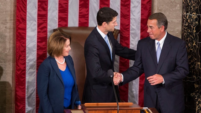 UNITED STATES - OCTOBER 29 - Incoming speaker Rep. Paul Ryan, R-Wis., shakes hands with outgoing Speaker John Boehner, R-Ohio, as House Minority Leader Nancy Pelosi, D-Calif., stands beside in the House Chambers of the U.S. Capitol in Washington, Thursday, October 29, 2015.