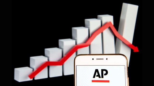 HONG KONG - 2018/12/14: In this photo illustration, the News agency Associated Press (AP) logo is seen displayed on an Android mobile device with a graph showing sharp losses in the background.
