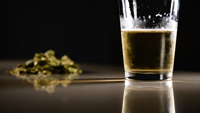 Close-Up Of Beer In Glass By Marijuana On Table - stock photo Photo taken in Miami, United States Erik Wieder / EyeEm via Getty Images
