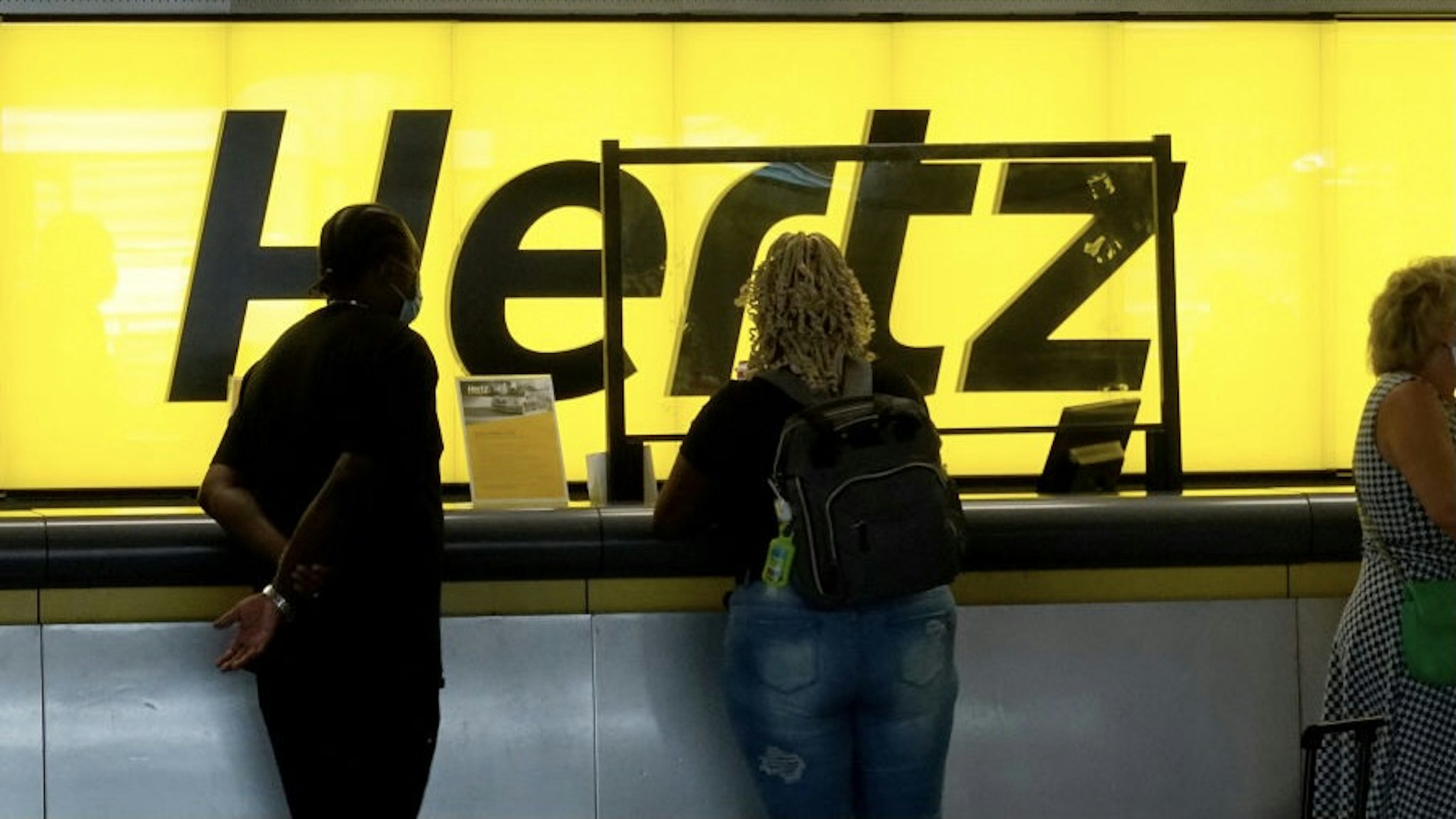 Hertz To Buy 100,000 Tesla Vehicles For Its Fleet FORT LAUDERDALE, FLORIDA - OCTOBER 25: People stand at a Hertz car rental counter in the Fort Lauderdale-Hollywood International Airport on October 25, 2021 in Miami, Florida. Hertz announced that it ordered 100,000 Teslas as the company is emerging from bankruptcy. (Photo by Joe Raedle/Getty Images) Joe Raedle / Staff