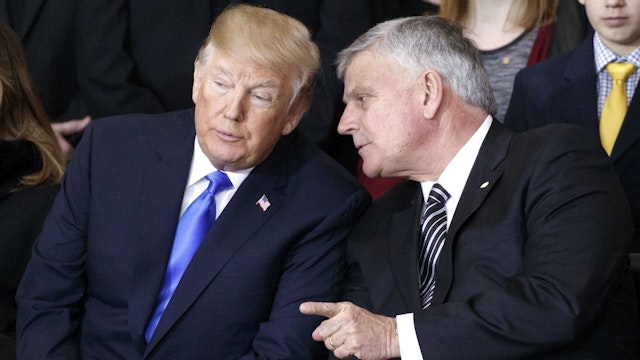 WASHINGTON, DC - FEBRUARY 28: (AFP-OUT) Franklin Graham (R) talks with President Donald Trump during a ceremony as the late evangelist Billy Graham lies in repose at the U.S. Capitol, on February 28, 2018 in Washington, DC. Rev. Graham is being honored by Congress by lying in repose inside of the U.S. Capitol Rotunda for 24 hours. Graham was the nation's best know Christian evangelist, preaching to millions worldwide, as well as being an advisor to US presidents over his six decade career.