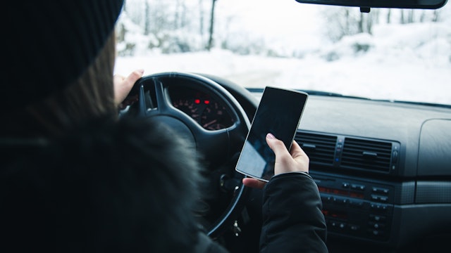 Distracted Driver Texting in Winter.