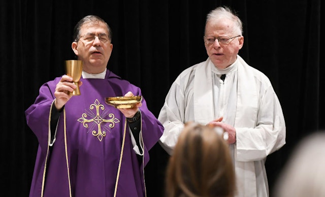 Father Frank Pavone, National Director of Priests for Life (left), celebrates Catholic Mass for attendees at the 2021 Conservative Political Action Conference at the Hyatt Regency. Former U.S. President Donald Trump is scheduled to speak on the final day of the conference.