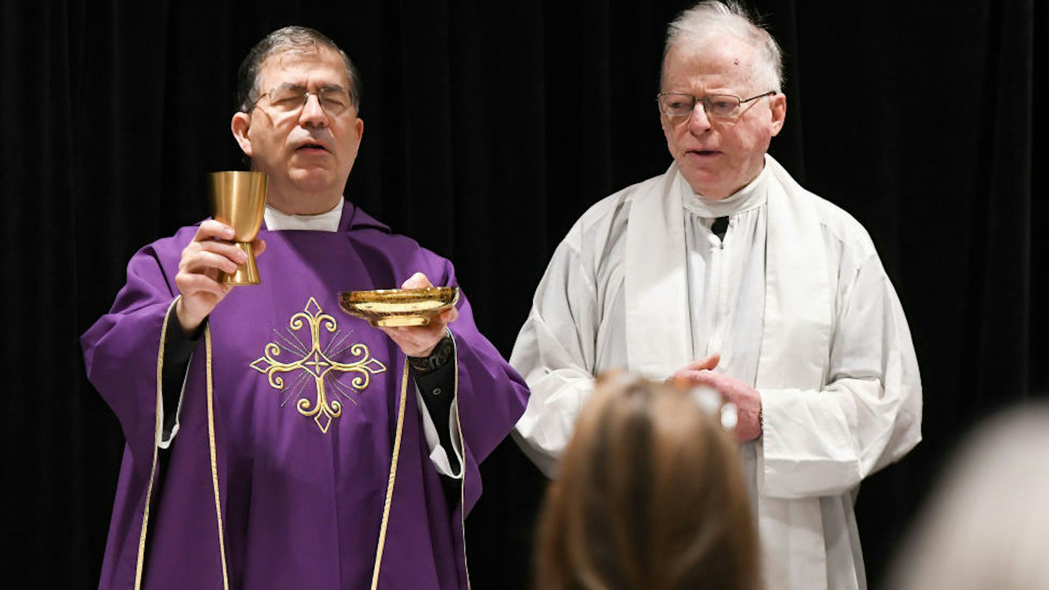 Father Frank Pavone, National Director of Priests for Life (left), celebrates Catholic Mass for attendees at the 2021 Conservative Political Action Conference at the Hyatt Regency. Former U.S. President Donald Trump is scheduled to speak on the final day of the conference.