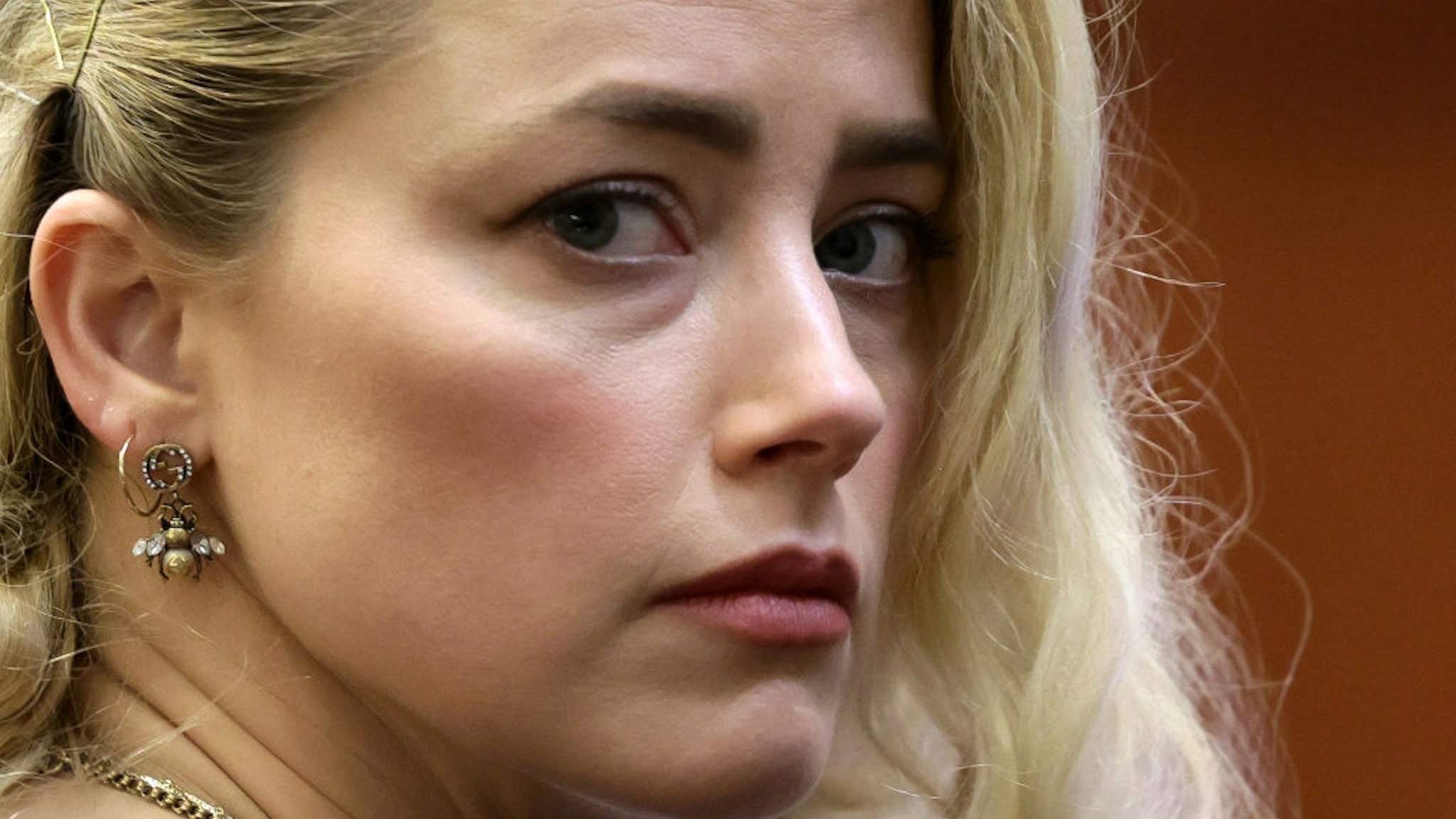 TOPSHOT - US actress Amber Heard waits before the jury announced a split verdict in favor of both Johnny Depp and Amber Heard on their claim and counter-claim in the Depp v. Heard civil defamation trial at the Fairfax County Circuit Courthouse in Fairfax, Virginia, on June 1, 2022. - A US jury on Wednesday found Johnny Depp and Amber Heard defamed each other, but sided far more strongly with the "Pirates of the Caribbean" star following an intense libel trial involving bitterly contested allegations of sexual violence and domestic abuse. (Photo by EVELYN HOCKSTEIN / POOL / AFP) (Photo by EVELYN HOCKSTEIN/POOL/AFP via Getty Images)