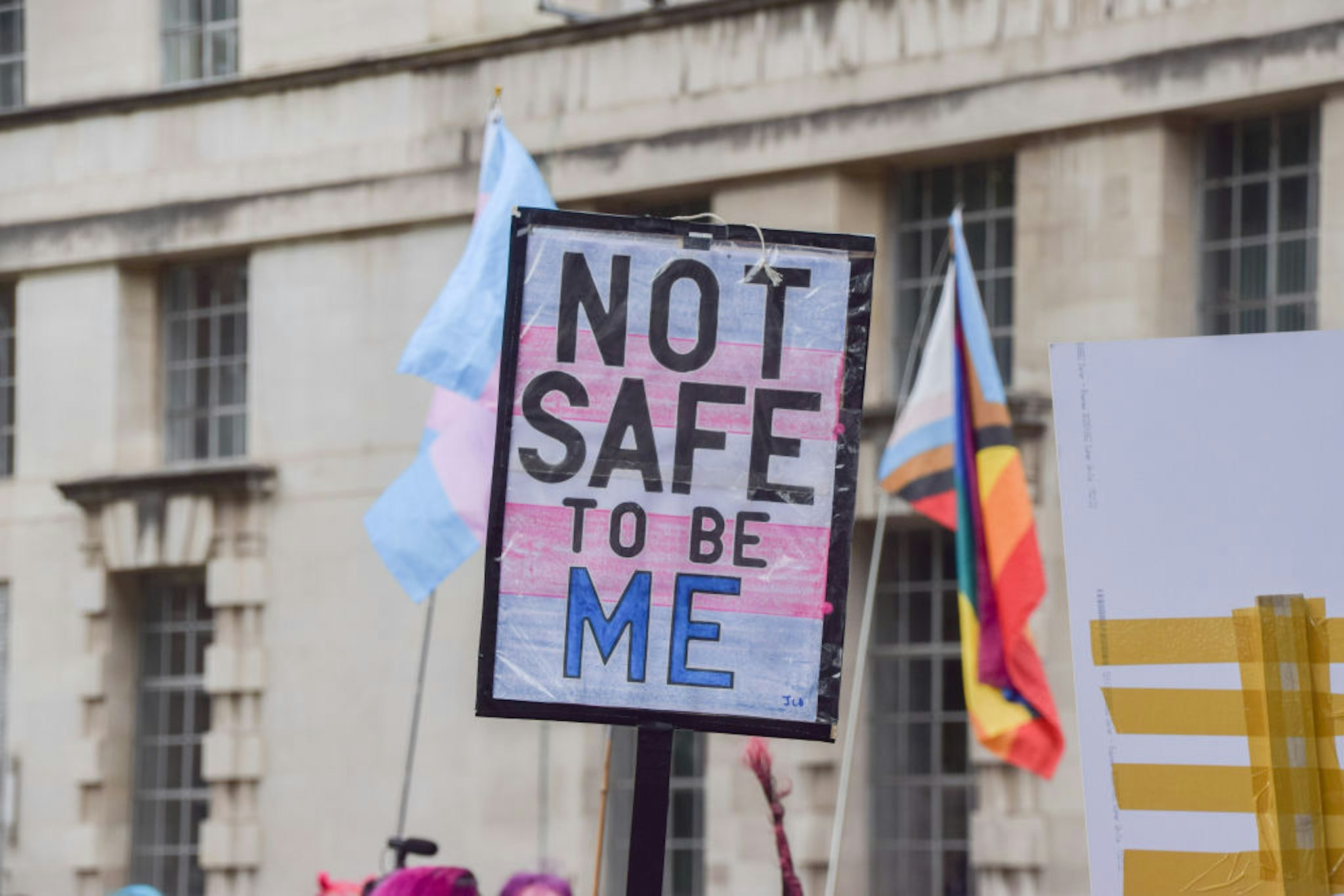 LONDON, UNITED KINGDOM - 2022/06/29: A protester holds a placard with the colours of the trans pride flag which reads "Not safe to be me" during the demonstration. Demonstrators gathered outside Downing Street in support of trans rights and demanded that the conversion therapy ban includes trans people. (Photo by Vuk Valcic/SOPA Images/LightRocket via Getty Images)