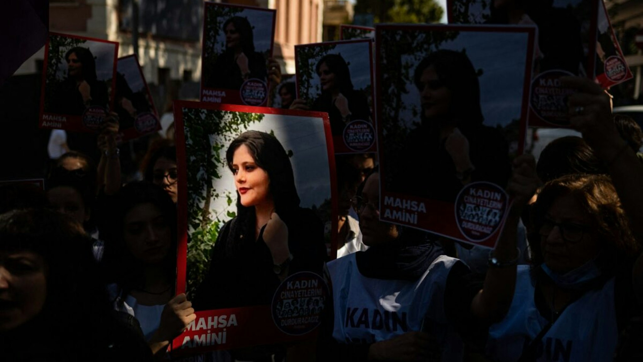 Protestors hold banners with the portrait of Iranian Mahsa Amini as they take part in a rally outside the Iranian consulate in Istanbul on September 29, 2022, as they protest following the death of Mahsa Amini after her arrest by the country's morality police in Tehran. -