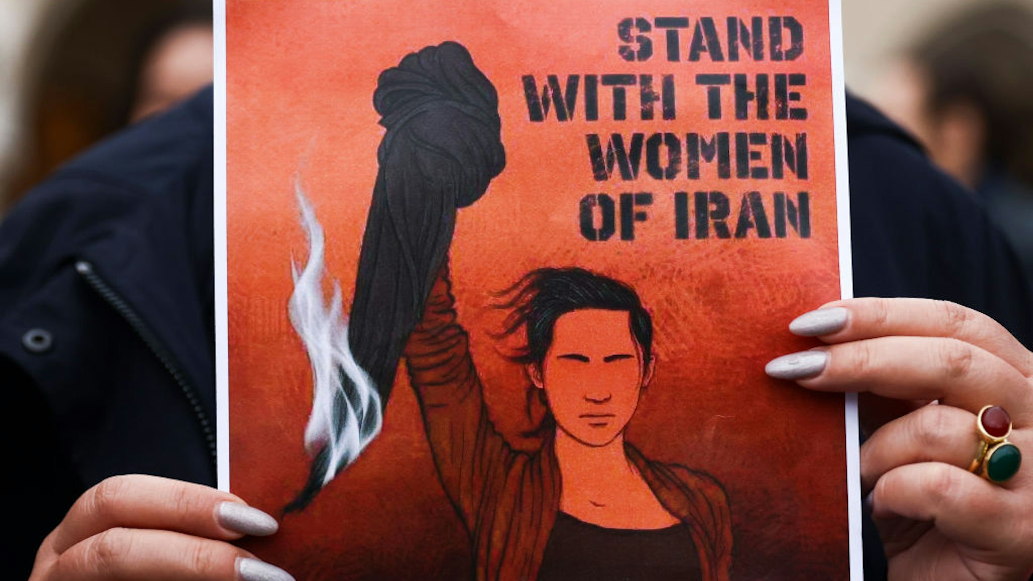 A banner 'Stand with the women of Iran' is seen during solidarity demonstration in memory of Mahsa Amini, at the Main Square in Krakow, Poland on October 1st, 2022.