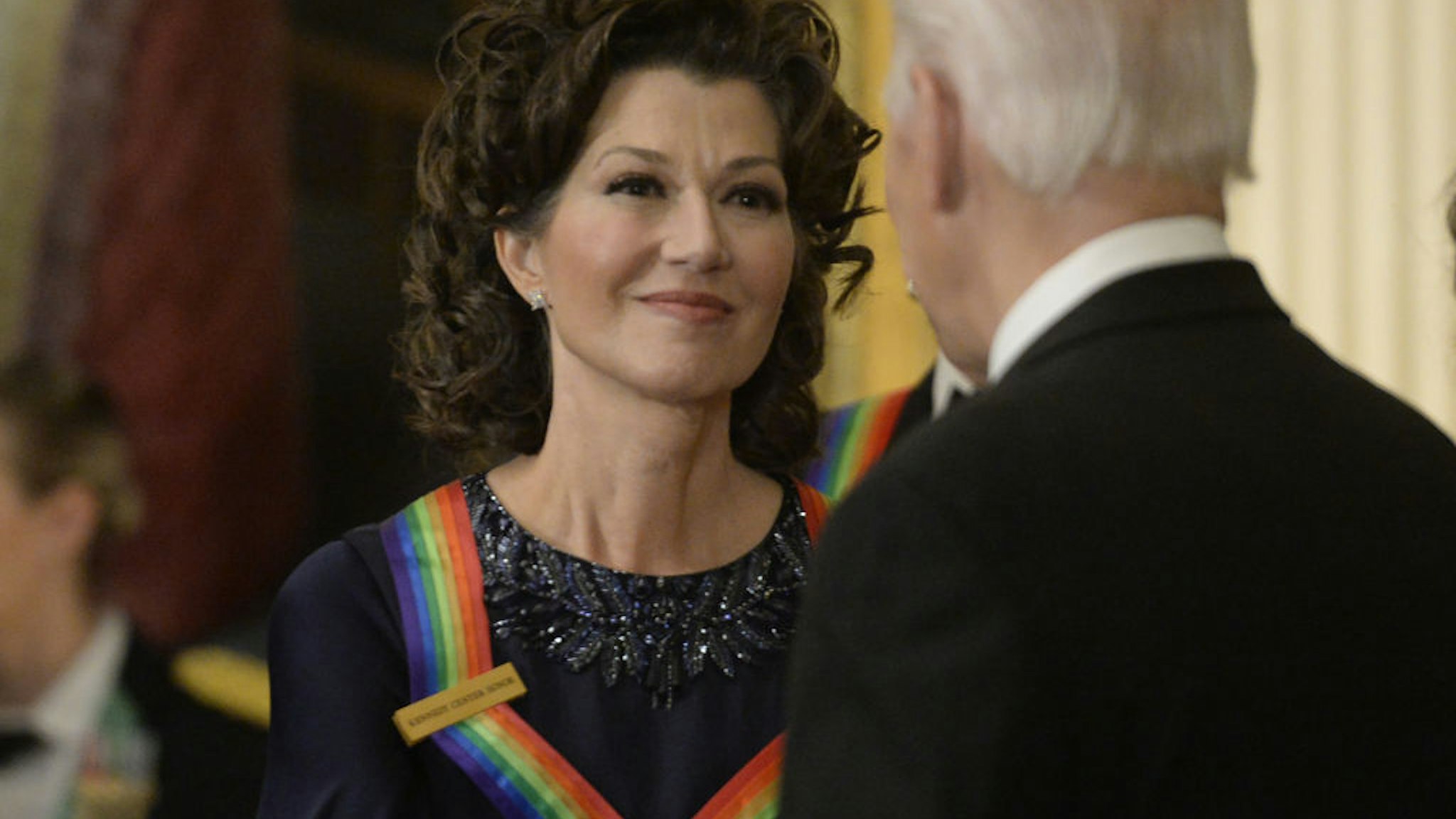 US President Joe Biden, right, greets musician Amy Grant during the Kennedy Center honoree reception in the East Room of the White House in Washington, DC, US, on Sunday, Dec, 4, 2022. The John F. Kennedy Center for the Performing Arts 45th honorees for lifetime artistic achievements include actor and filmmaker George Clooney, contemporary Christian singer-songwriter Amy Grant, singer Gladys Knight, composer and conductor Tania Leon and Irish rock band U2. Photographer: Bonnie Cash/UPI/Bloomberg via Getty Images