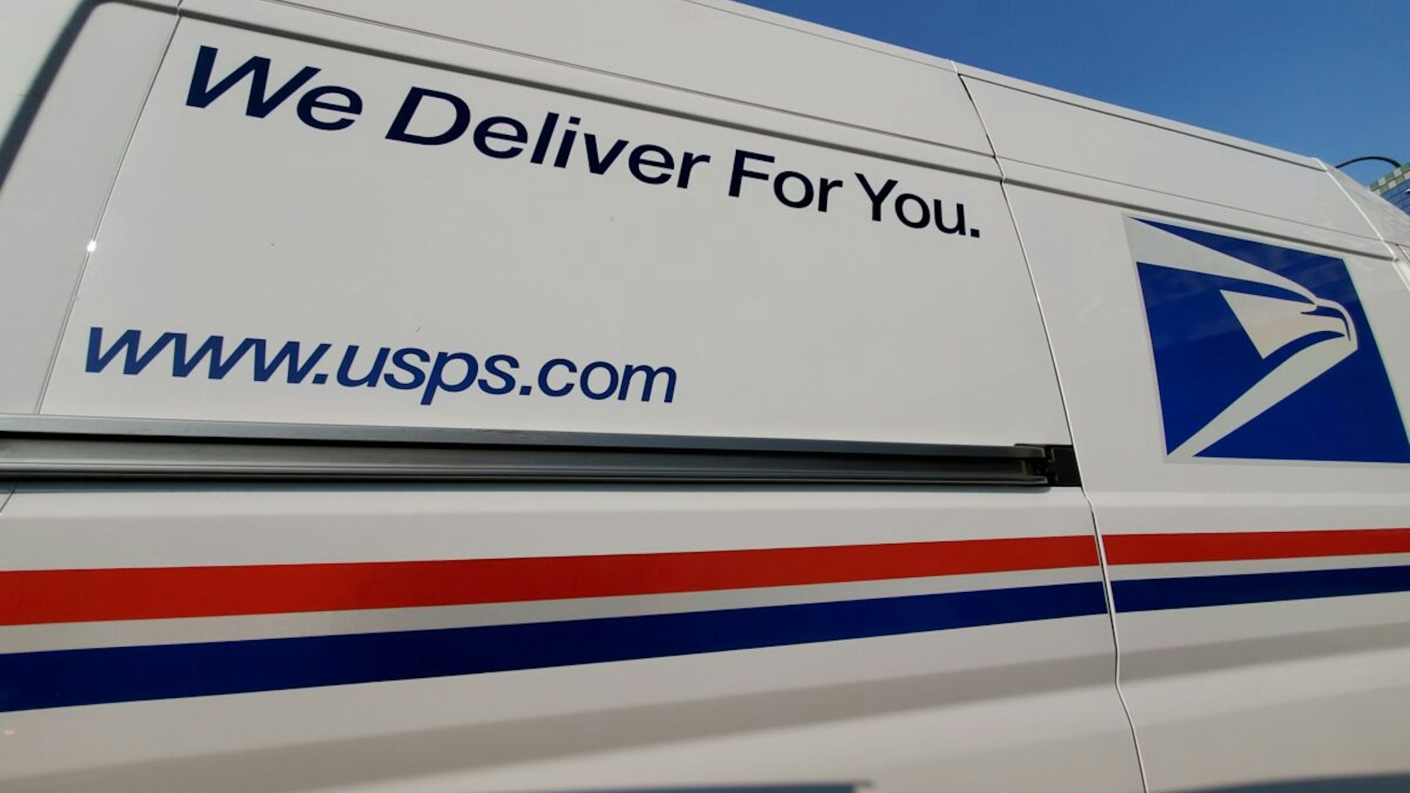 Wide angle view of United States Postal Service (USPS) truck with logo visible, Lafayette, California, September 17, 2020.
