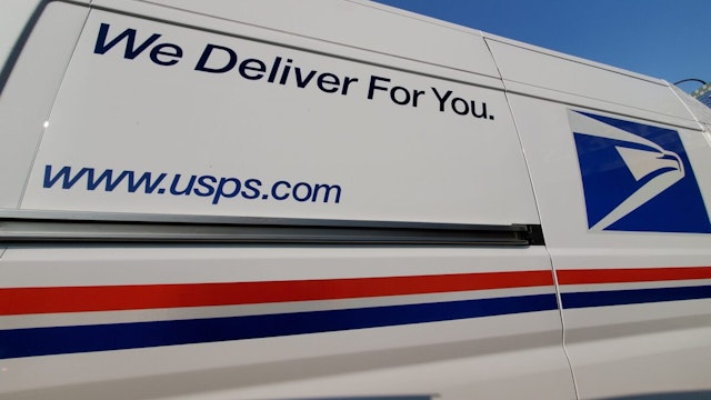 Wide angle view of United States Postal Service (USPS) truck with logo visible, Lafayette, California, September 17, 2020.