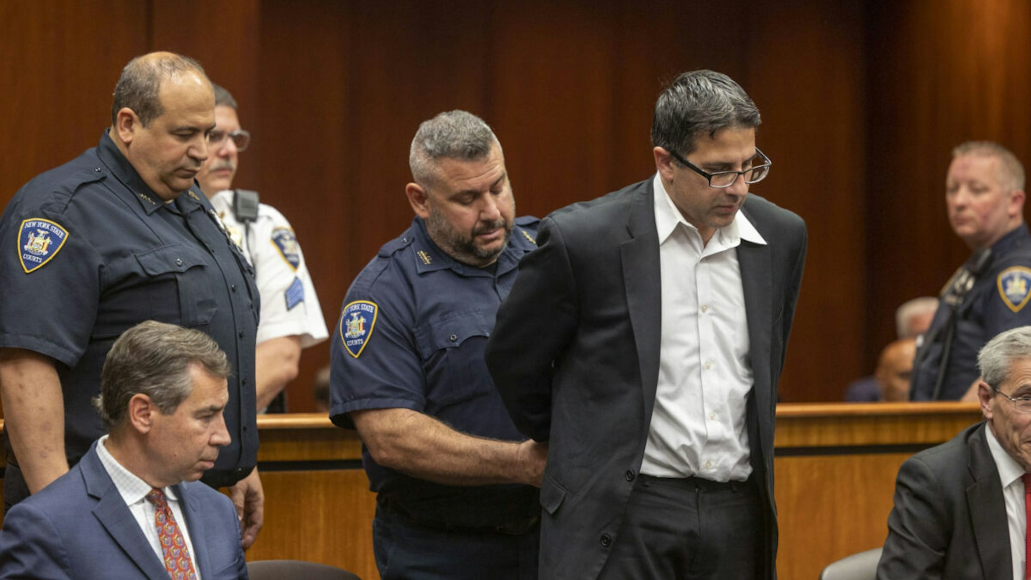 Former NYPD officer Michael Valva is handcuffed after the guilty verdict was read during his trial at Suffolk Criminal Court in Riverhead, New York on November 4, 2022.