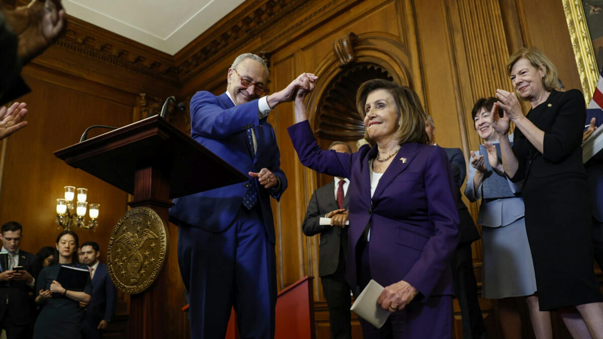 Nancy Pelosi and Chuck Schumer House Speaker Nancy Pelosi (D-CA) high fives Senate Majority Leader Chuck Schumer (D-NY) as Sen. Susan Collins (R-ME) and Sen. Tammy Baldwin (D-WI) look on during a bill enrollment ceremony for the Respect For Marriage Act at the U.S. Capitol Building on December 08, 2022 in Washington, DC.
