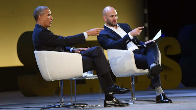 Former US President Barack Obama speaks with Sam Kass during the Seeds&Chips Global Food Innovation Summit on May 9, 2017 in Milan, Italy.