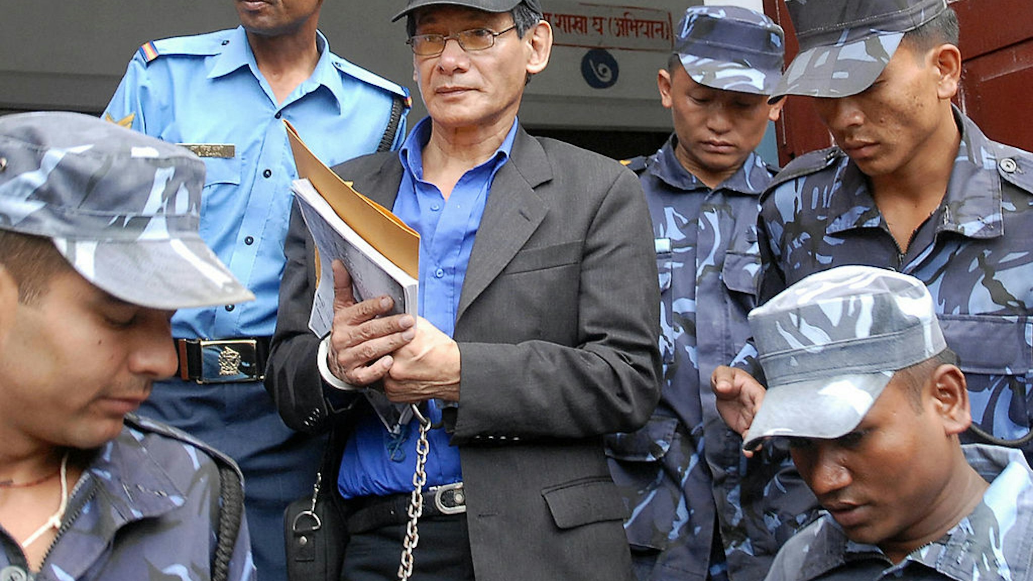 French serial killer Charles Sobhraj (C) is guided by Nepalese policemen towards a waiting vehicle after a court ruling in Kathmandu on August 18, 2008.