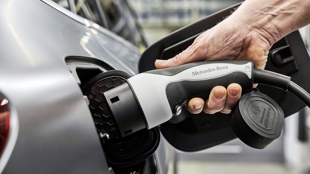 An employee connects an electric charging plug to a Mercedes-Benz AG EQC 400 luxury electric automobile at the Daimler AG factory in Bremen, Germany, on Wednesday, Jan. 29, 2020. Traditional automakers have been forced to rethink the market as they confront new emissions rules, rapidly changing technology and potent competition from the likes of e-car pioneer Tesla Inc. and new tech-industry entrants