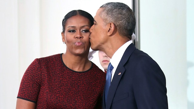 WASHINGTON, DC - JANUARY 20: President Barack Obama gives a kiss to his wife first lady Michelle Obama before the arrival of President-elect Donald Trump and his wife Melania Trump, at the White House on January 20, 2017 in Washington, DC. Later in the morning President-elect Trump will be sworn in as the nation's 45th president during an inaugural ceremony at the U.S. Capitol.