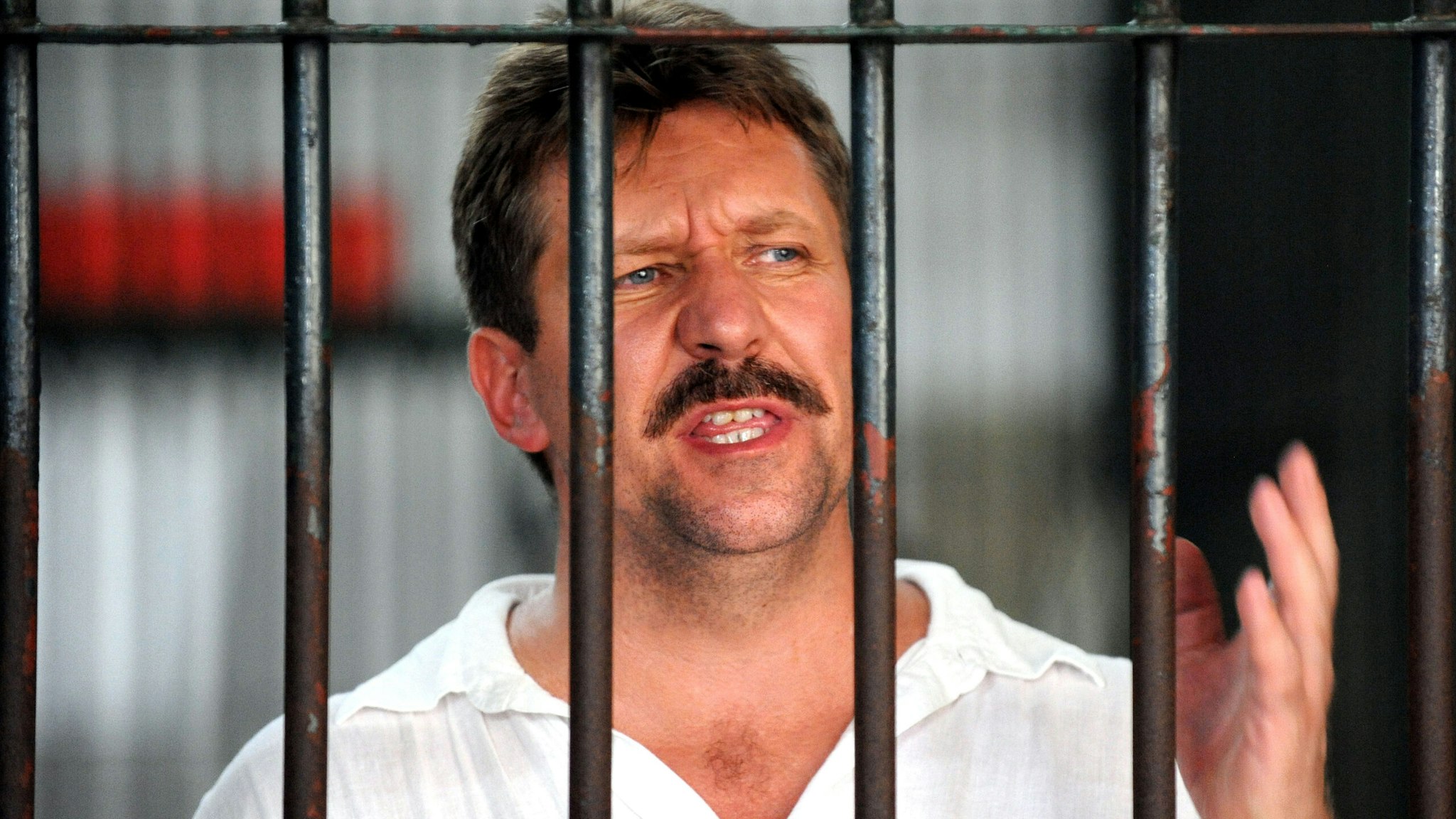Russian arms dealer Viktor Bout speaks to the press from behind his cell bars of the criminal court detention center in Bangkok on April 9, 2008. Thailand will not prosecute Russian arms dealer Viktor Bout in local courts, clearing the way for the extradition of the "Merchant of Death" to the United States, police and lawyers said. Bout, who is accused of funnelling weapons to some of the world's deadliest conflicts, was arrested on March 6 in Bangkok in a sting operation with US anti-drug agents on a warrant on charges of procuring assets for terrorists.