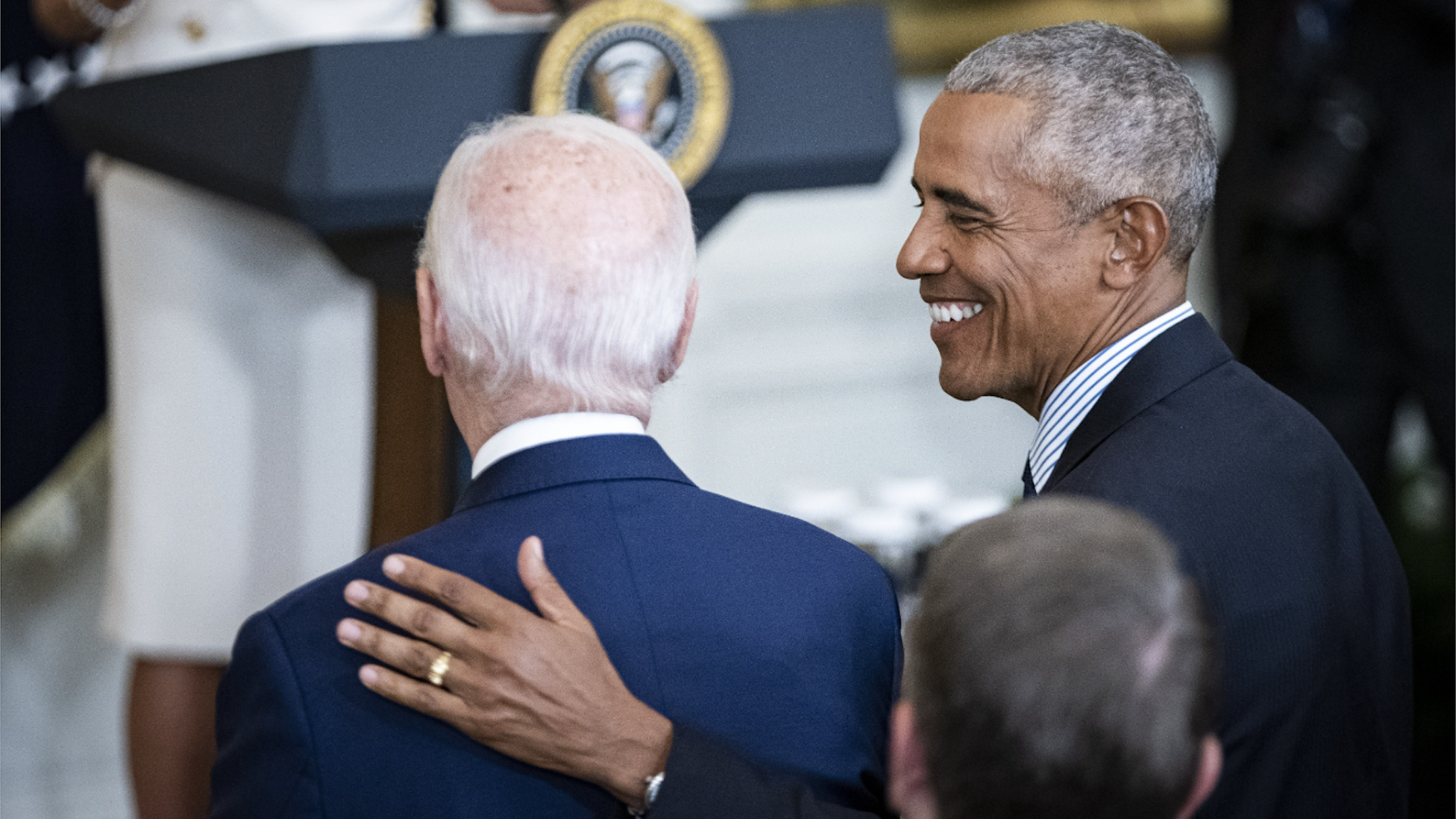 Former US President Barack Obama, right, embraces US President Joe Biden during a ceremony for the unveiling of his official White House portrait in Washington, D.C., US, on Wednesday, Sept. 7, 2022. The portraits of Barack Obama and Michelle Obama, acquired and commissioned by the White House Historical Association, were painted by Robert McCurdy and Sharon Sprung, respectively.