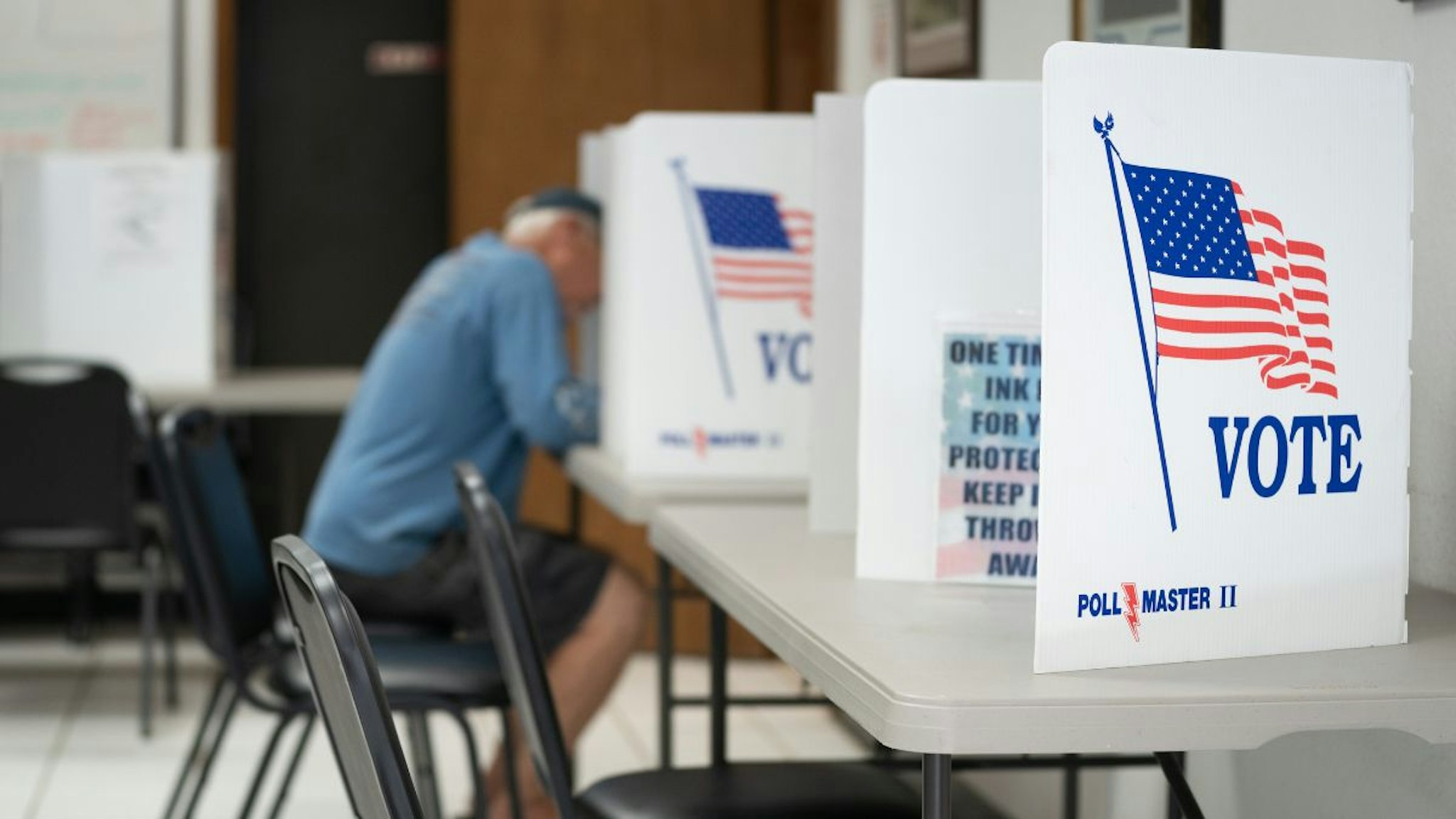 A man fills out a ballot at a voting booth on May 17, 2022 in Mt. Gilead, North Carolina.