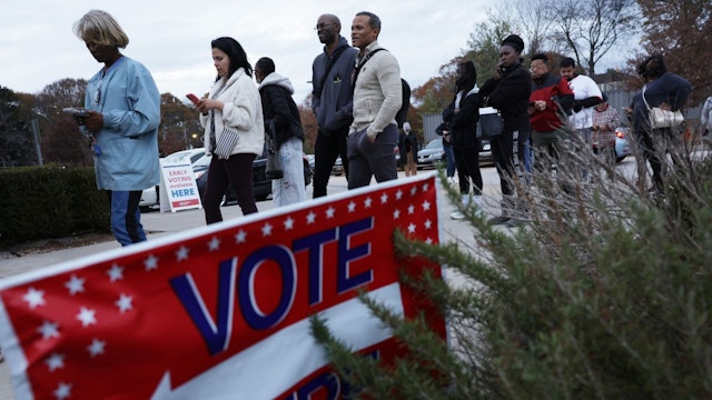 Residents wait in line to vote early outside a polling station on November 29, 2022 in Atlanta, Georgia.