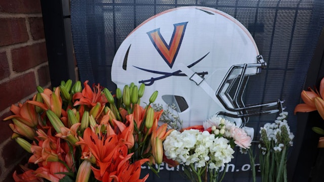 Flowers left outside Scott Stadium at a makeshift memorial for three University of Virginia football players killed during an overnight shooting at the university on November 14, 2022 in Charlottesville, Virginia.