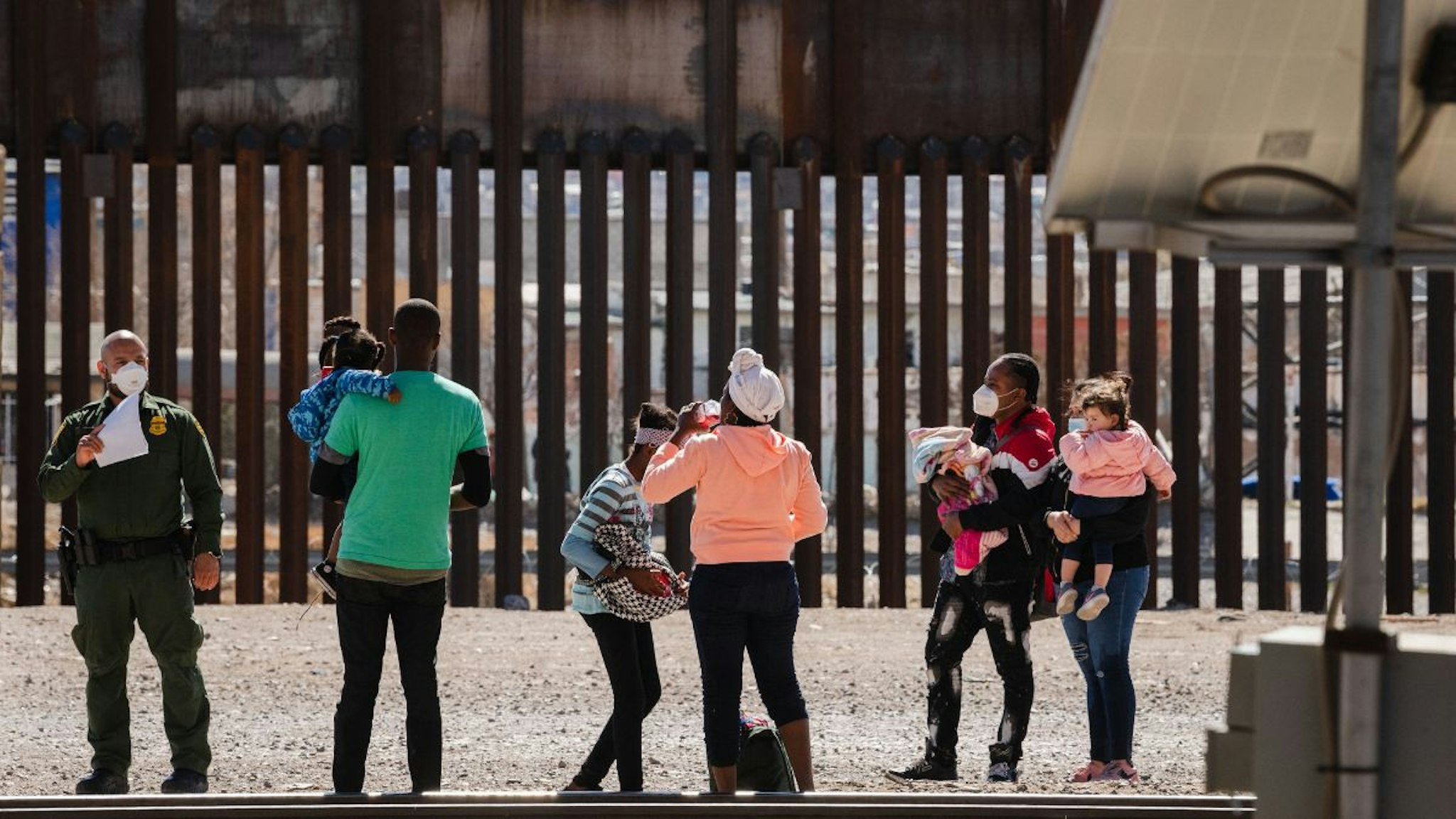 Border Patrol agents apprehend a group of migrants near downtown El Paso, Texas following the congressional border delegation visit on March 15, 2021.