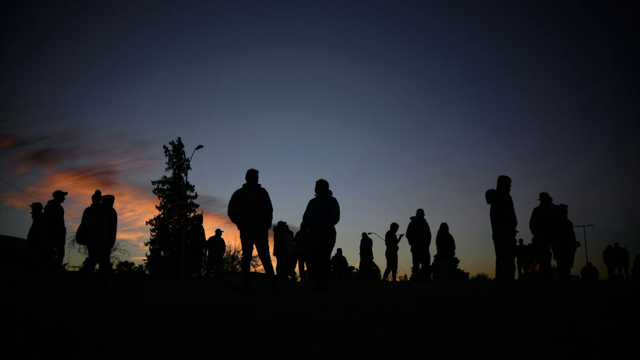 Venezuelan migrants communicate with their families and friends at the camp area in front of the US Border Patrol operations post across the Rio Bravo River in the evening hours in Mexico on November 14, 2022.