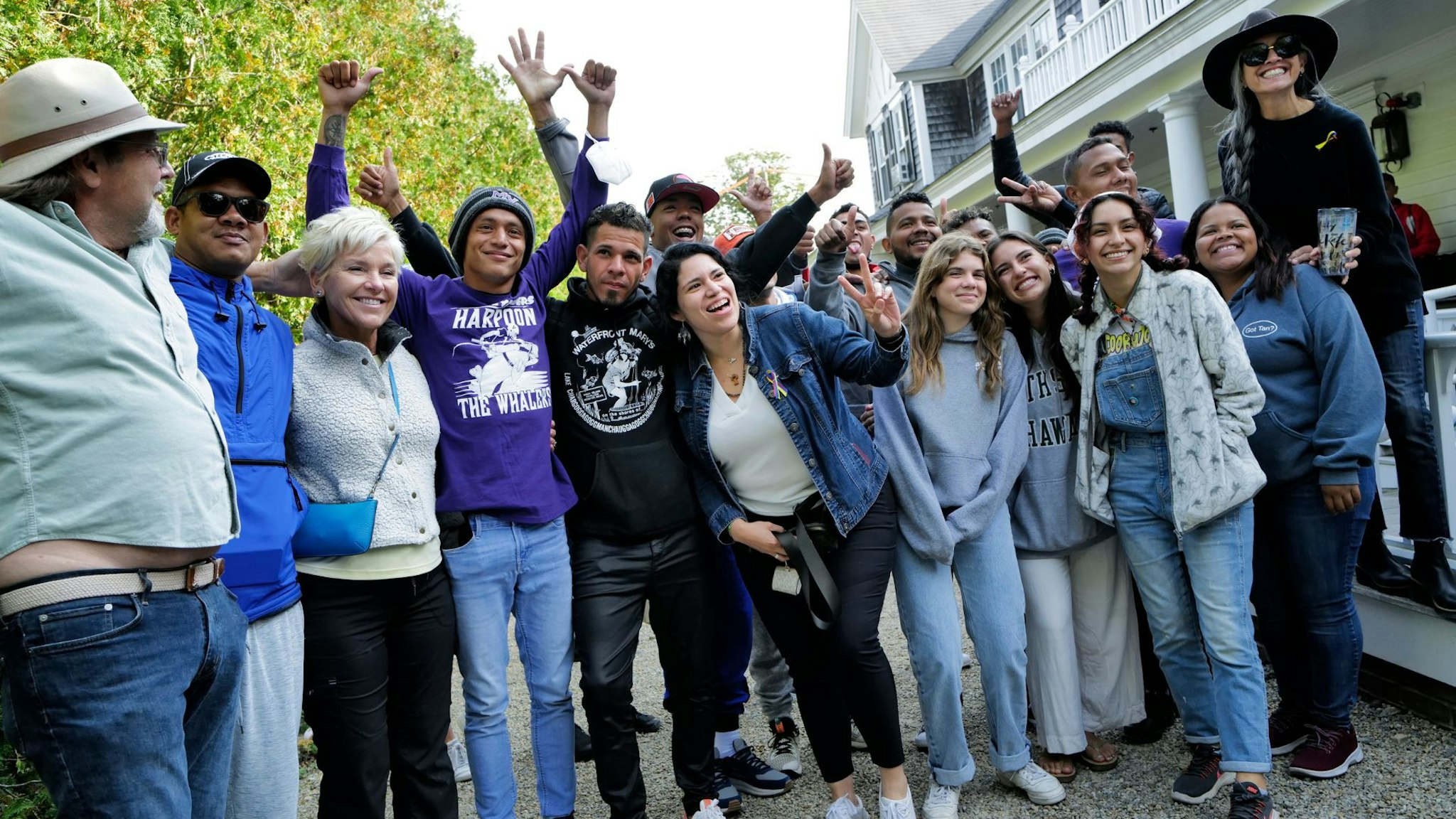 Martha's Vineyard, MA - September 16: Venezuelan migrants and volunteers celebrate together outside of St. Andrew's Parish House. Two planes of migrants from Venezuela arrived suddenly two days prior causing the local community to mobilize and create a makeshift shelter at the church.