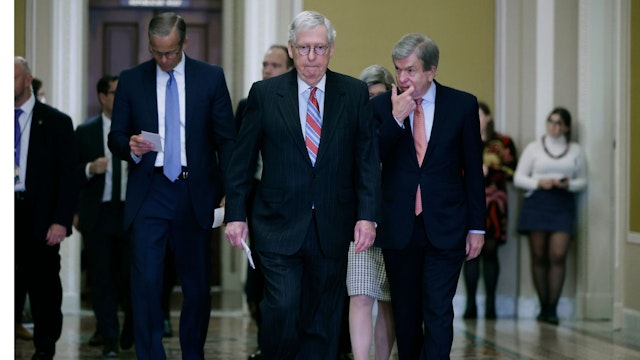 WASHINGTON, DC - DECEMBER 20: Senate Minority Leader Mitch McConnell (R-KY) (C) is joined by Senate Minority Whip John Thune (R-SD) and Sen. Roy Blunt (R-MO) as they head to a news conference following the weekly Republican Senate policy luncheon at the U.S. Capitol on December 20, 2022 in Washington, DC. McConnell said that both Republicans and Democrats got what they wanted in the proposed federal omnibus spending legislation that was agreed to early that morning, which would help avert a government shutdown days before Christmas. (