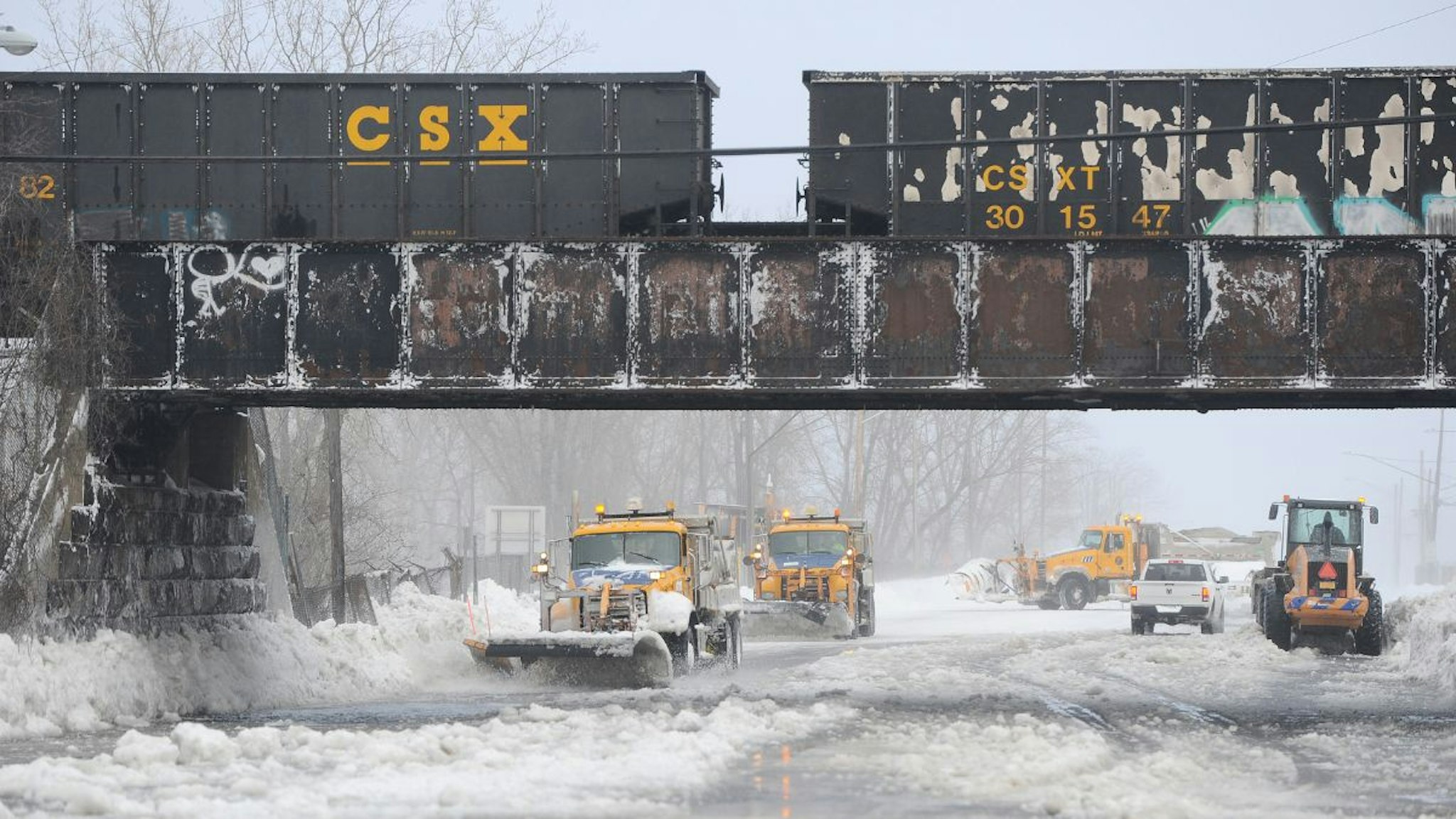 Plows work to clear ice and snow along the Lake Erie shoreline on December 24, 2022 in Hamburg, New York.