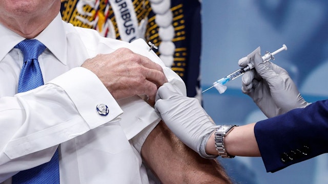 U.S. President Joe Biden receives his updated COVID-19 booster in the South Court Auditorium at the White House campus on October 25, 2022 in Washington, DC.
