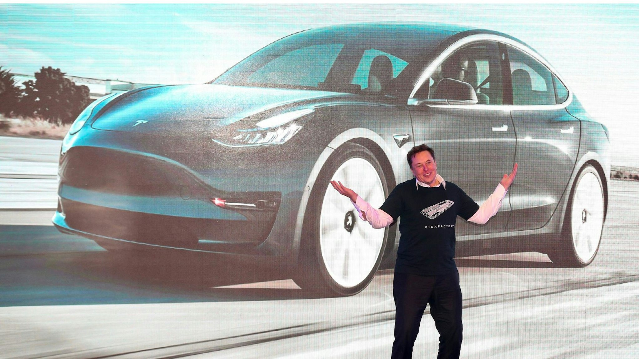 Tesla CEO Elon Musk gestures during the Tesla China-made Model 3 Delivery Ceremony in Shanghai. - Tesla CEO Elon Musk presented the first batch of made-in-China cars to ordinary buyers on January 7, 2020 in a milestone for the company's new Shanghai "giga-factory", but which comes as sales decelerate in the world's largest electric-vehicle market.