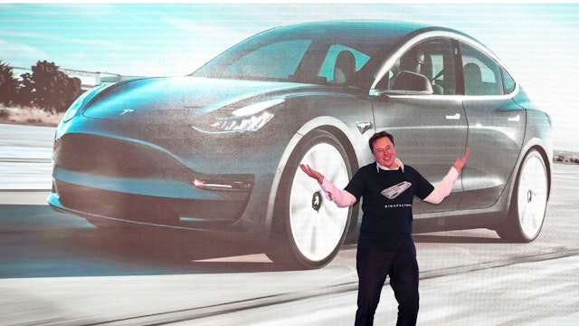 Tesla CEO Elon Musk gestures during the Tesla China-made Model 3 Delivery Ceremony in Shanghai. - Tesla CEO Elon Musk presented the first batch of made-in-China cars to ordinary buyers on January 7, 2020 in a milestone for the company's new Shanghai "giga-factory", but which comes as sales decelerate in the world's largest electric-vehicle market.