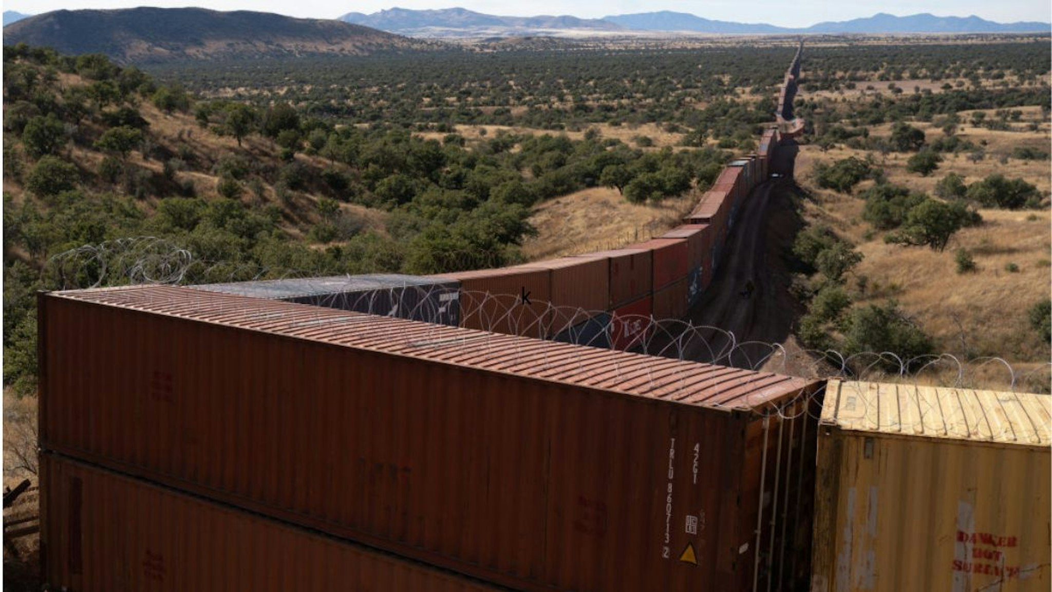 Shipping containers line the US and Mexico Border at Coronado National Memorial in Cochise County, Arizona, US, on Sunday, Dec. 11, 2022.