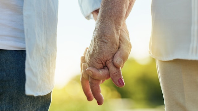 Hold my hand and let's make it last - stock photo Cropped shot of a senior couple holding hands in a park PeopleImages via Getty Images